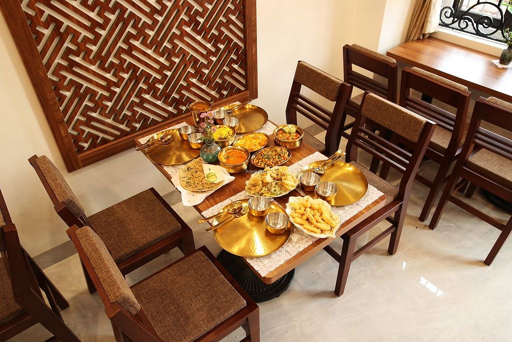 Indian vegetarian dishes served on brass plates at KP Restaurant